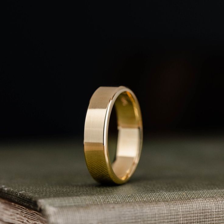 a gold ring sitting on top of a book