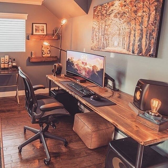 a home office with two computer monitors on the desk