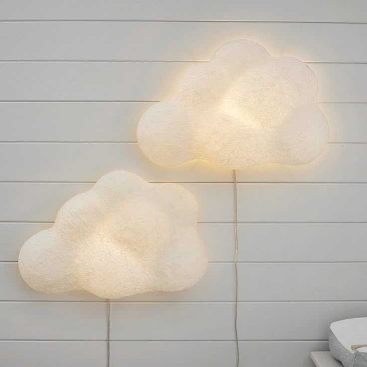 two white clouds are on the wall next to each other