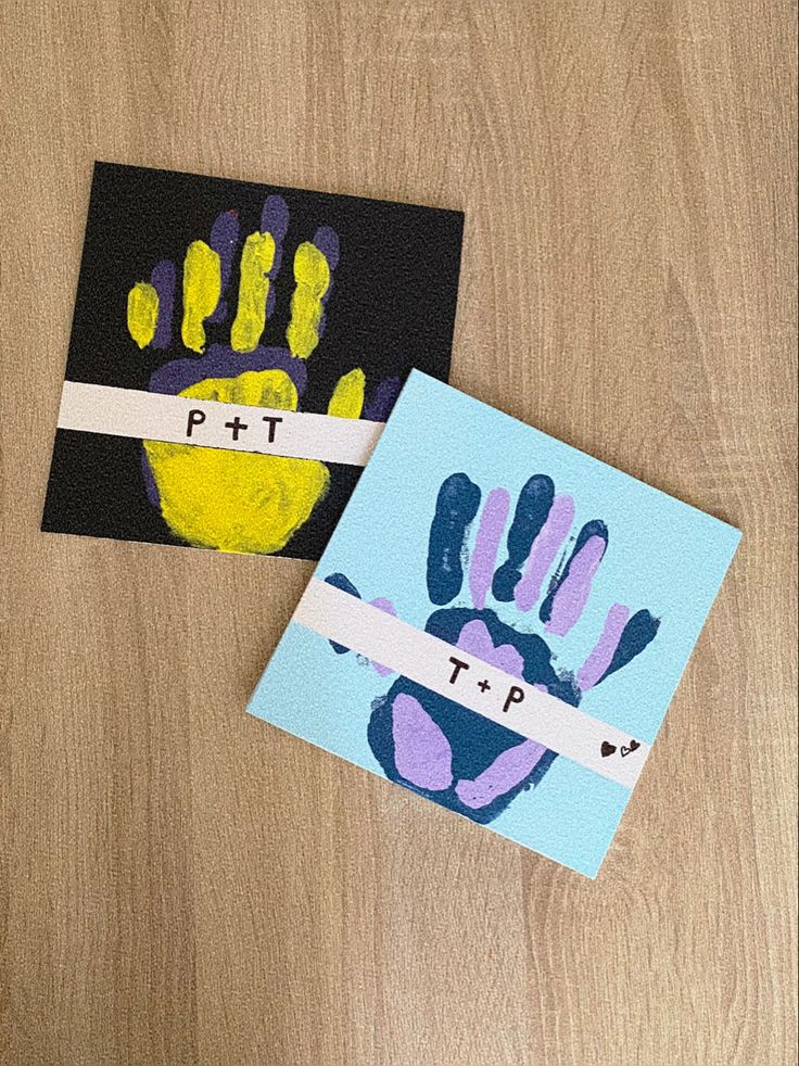 two handprints are placed on top of each other, one is blue and the other is yellow