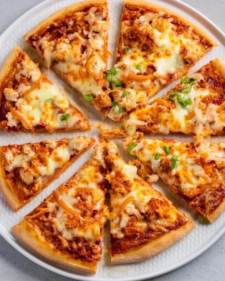 a pizza cut into eight slices on a white plate