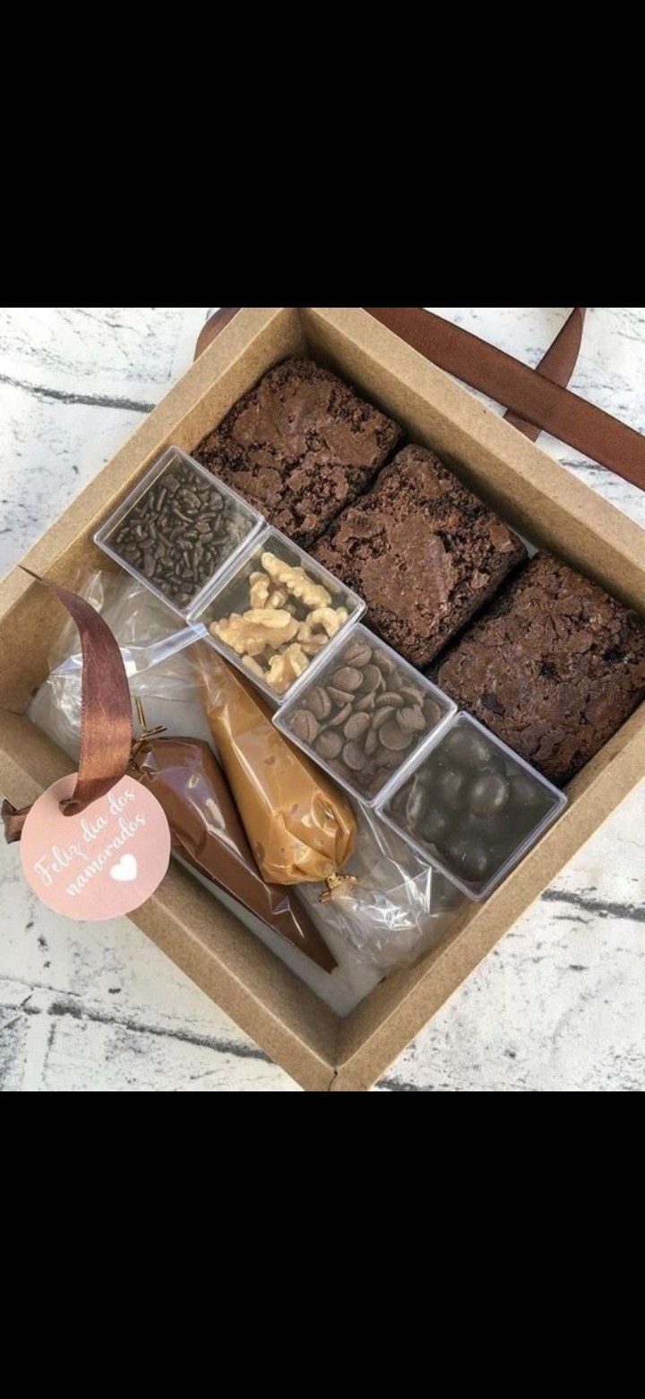 a box filled with lots of different types of chocolates and cookies on top of a table