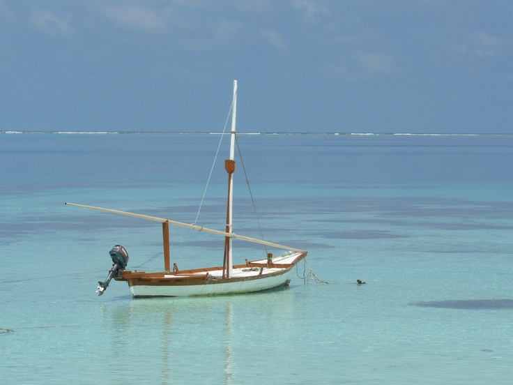 a small boat floating on top of a body of water