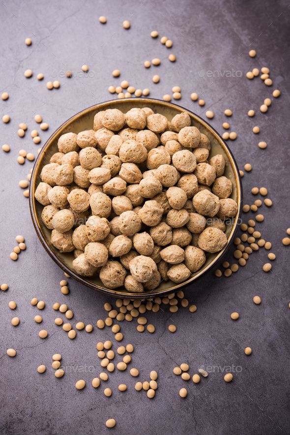 a bowl full of chickpeas on top of a table next to some beans