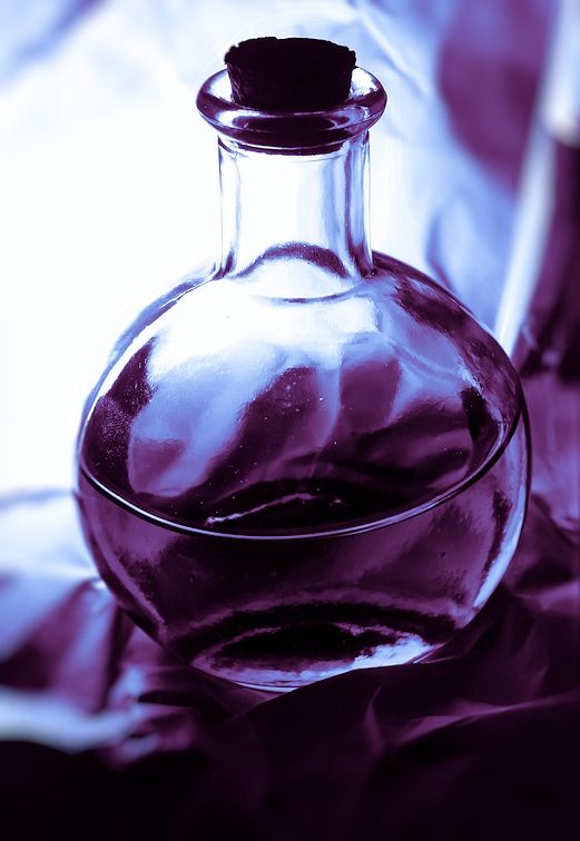 an empty glass bottle sitting on top of a table