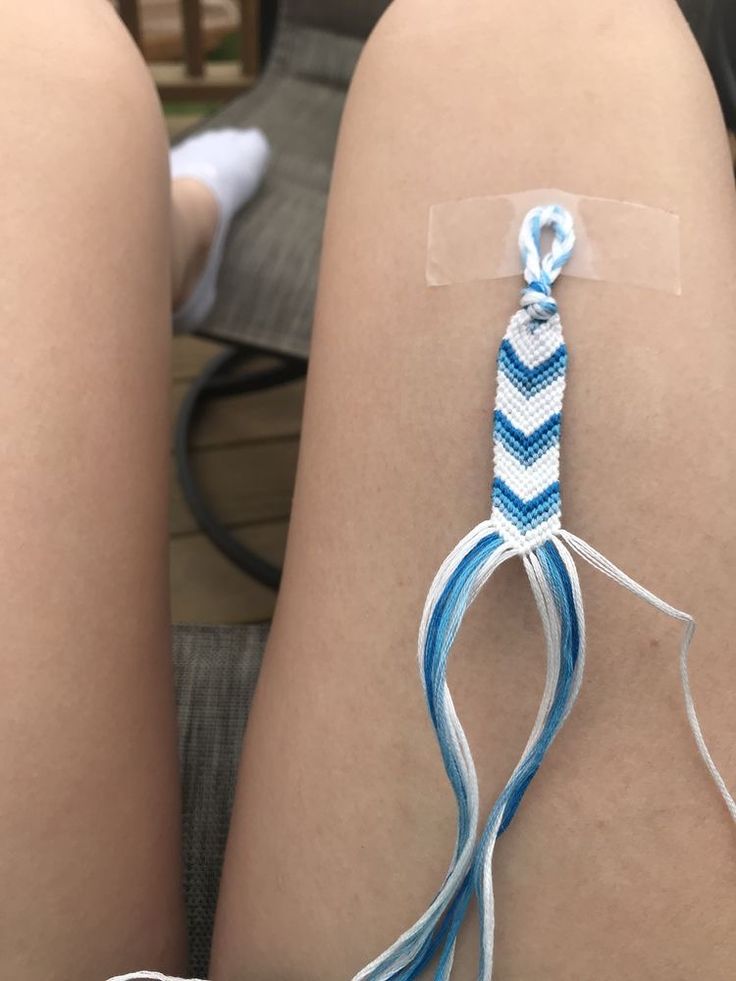 two legs with blue and white cords attached to them, sitting next to each other