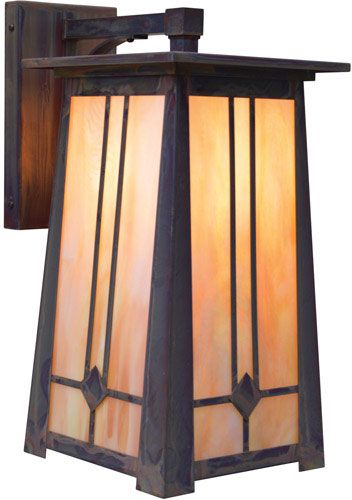 a light that is on the side of a wall mounted fixture with stained glass panels