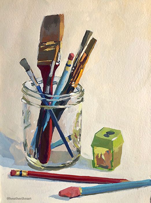 a jar filled with lots of different types of art supplies