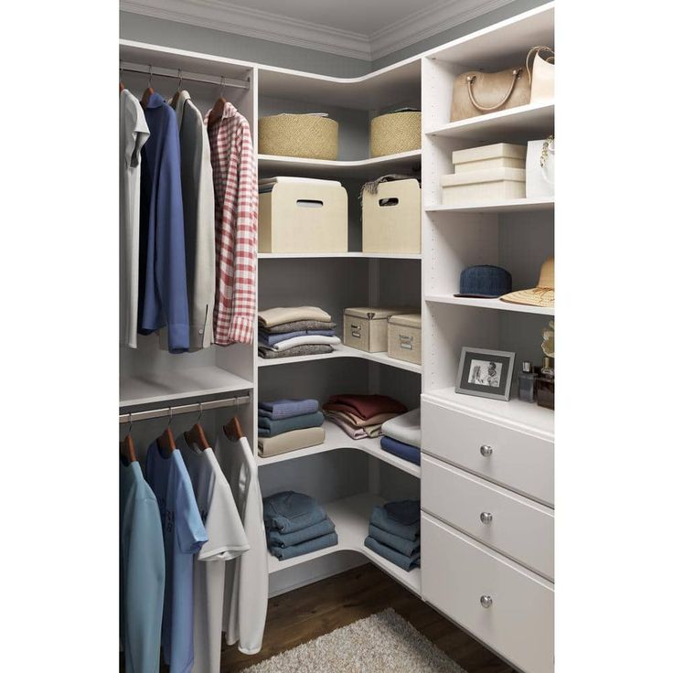 an organized closet with white shelving and drawers