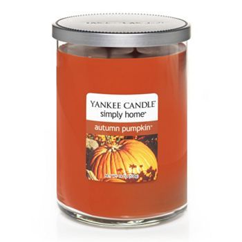 an orange jar filled with pumpkin candles