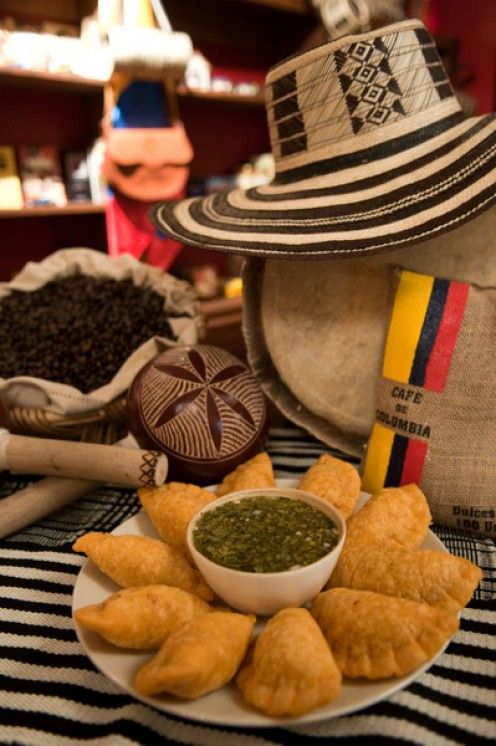 an assortment of food on a plate with a hat and other items in the background