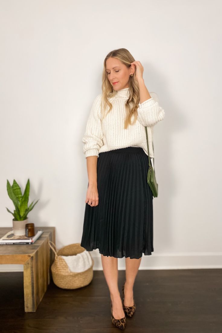 Holiday outfit idea with a cream turtleneck sweater, black pleated midi skirt, and leopard print heels. Michelle Tomczak BIog. Black Pleated Skirt Outfit Winter, Black Pleated Midi Skirt Outfit, Midi Pleated Skirt Outfit, Black Pleated Skirt Outfit, Pleated Midi Skirt Outfit, Midi Skirt Outfit Winter, Holiday Skirt Outfits, Sweater Skirt Outfit, Midi Sweater Skirt