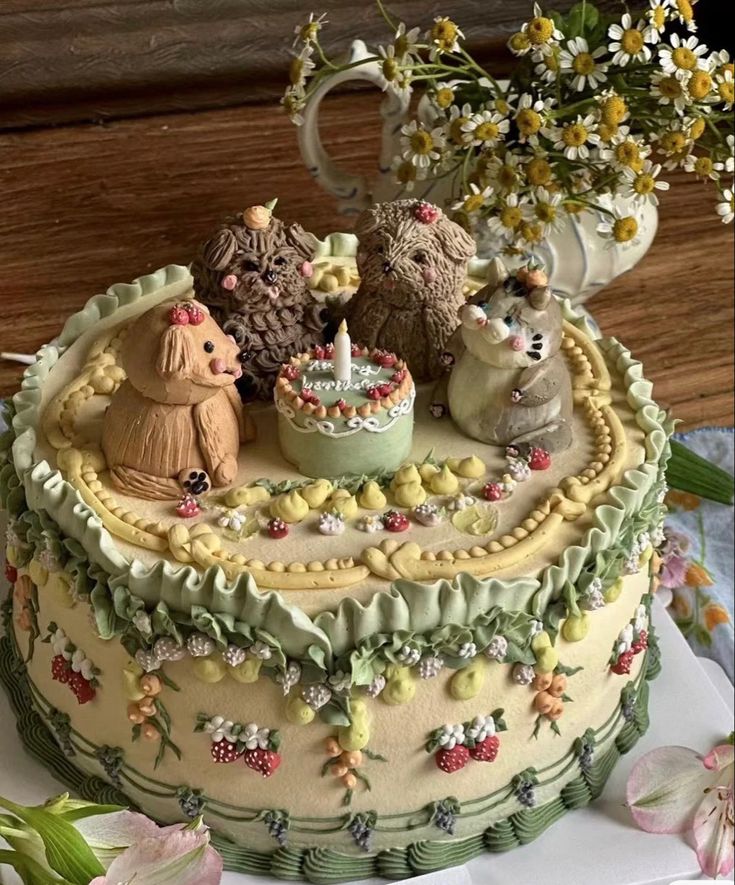 there is a cake decorated with animals and flowers