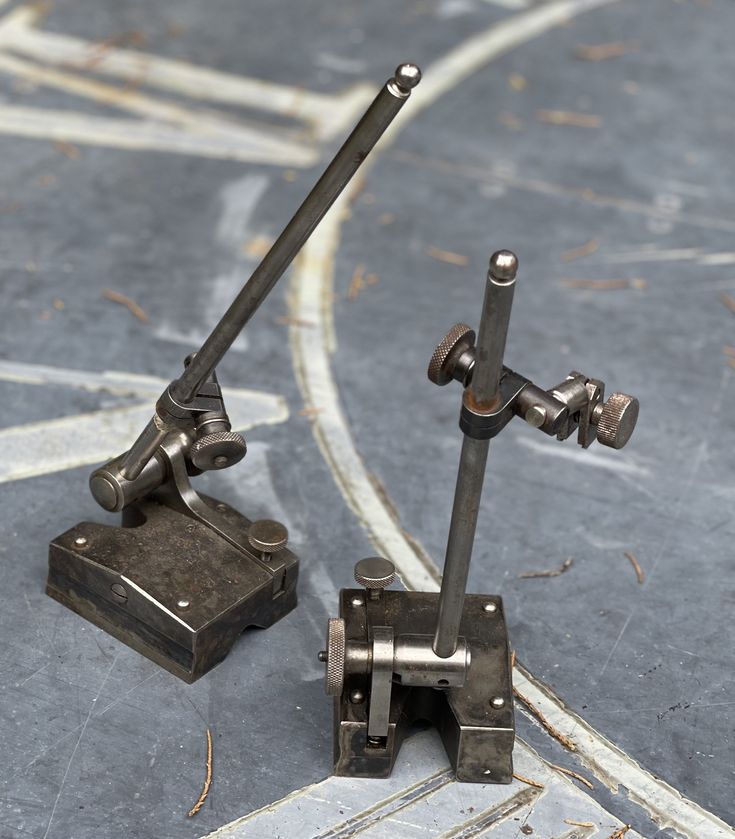 two metal objects sitting on top of a floor