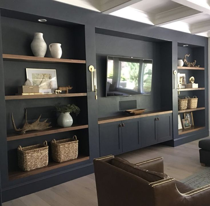 a living room filled with furniture and lots of shelves