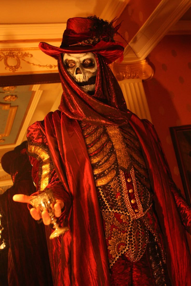 a skeleton dressed up in red and gold