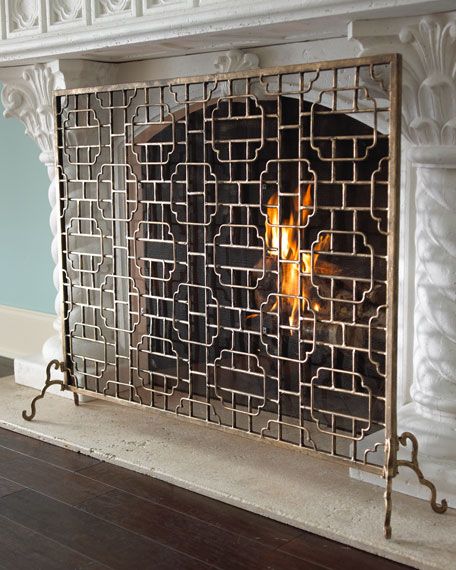 an ornate fireplace screen in the middle of a room