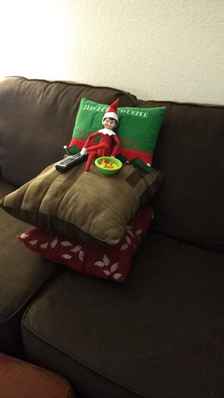 an elf sitting on top of a brown couch