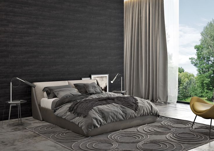 a modern bedroom with black walls and grey bedding