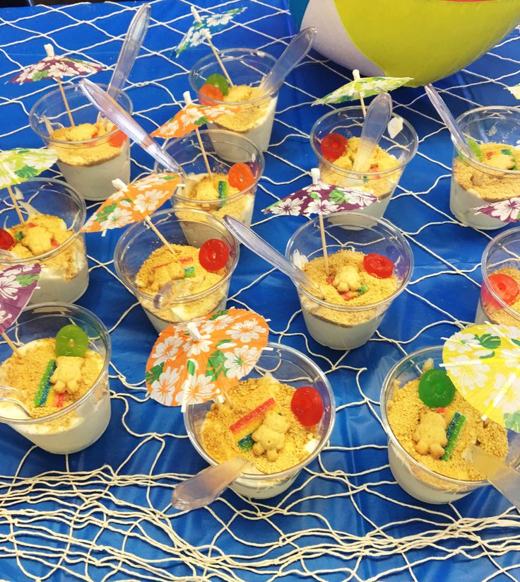 desserts in plastic cups on a blue tablecloth