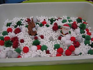 a plastic container filled with snow and christmas decorations