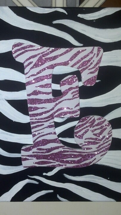 the letter e is made up of zebra stripes and pink glitters on black paper