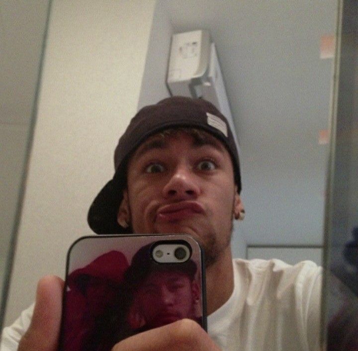 a man taking a selfie in front of a bathroom mirror with his cell phone