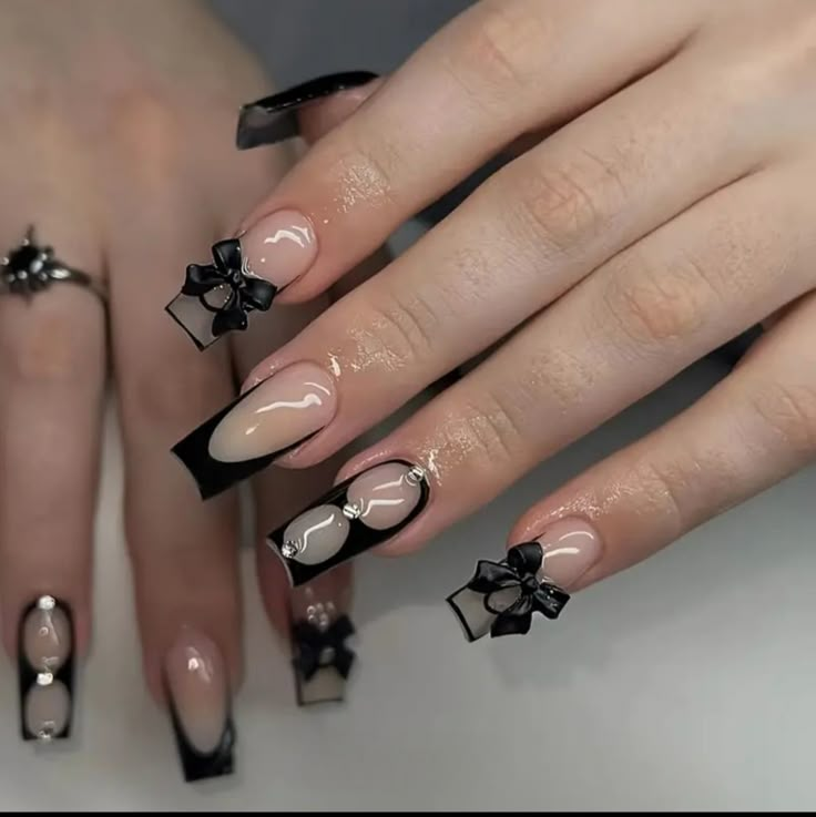 a woman's hands with black and white nail designs