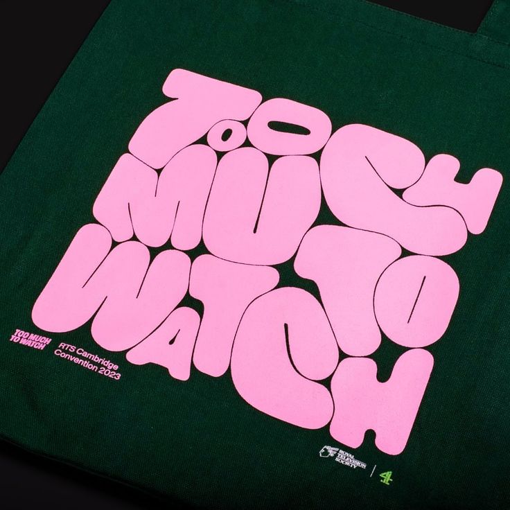 a green tote bag with pink lettering on it