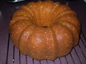 a bundt cake sitting on top of a metal rack