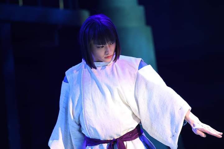 a woman in a kimono holding out her arms