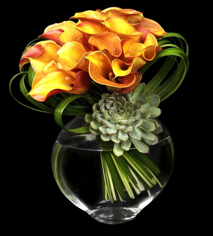 an arrangement of flowers in a glass vase