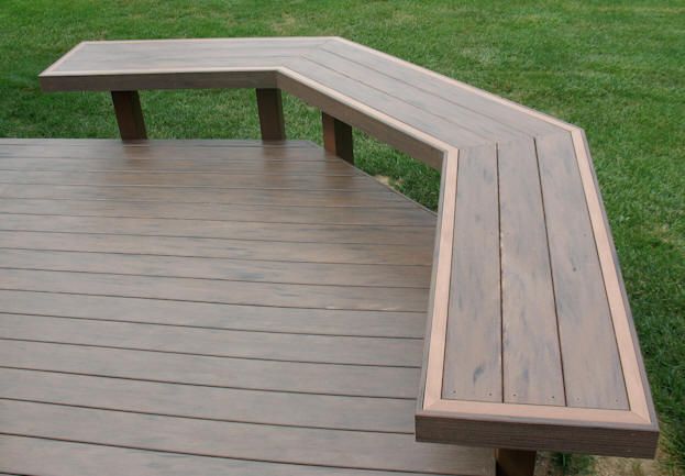 a bench sitting on top of a wooden deck