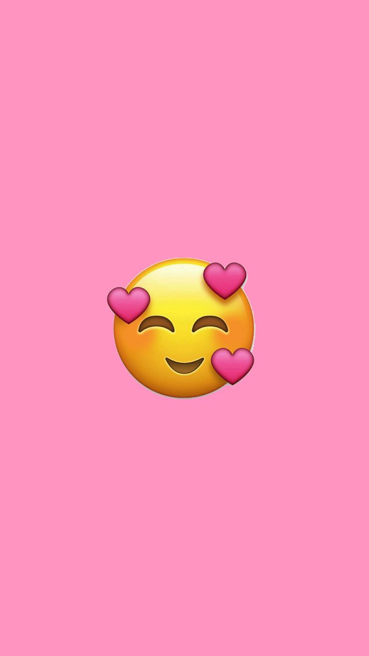 an emoticive smiley face with hearts on pink background