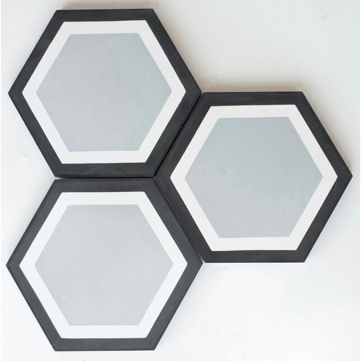 three black and white hexagonal mirrors on the wall