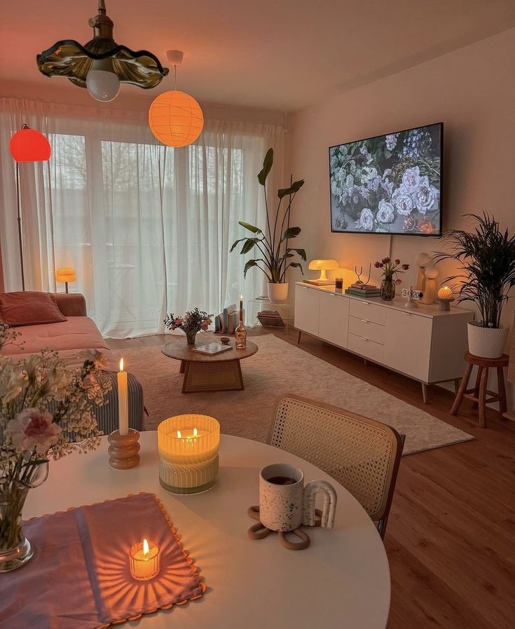 a living room filled with furniture and a flat screen tv mounted to the side of a wall