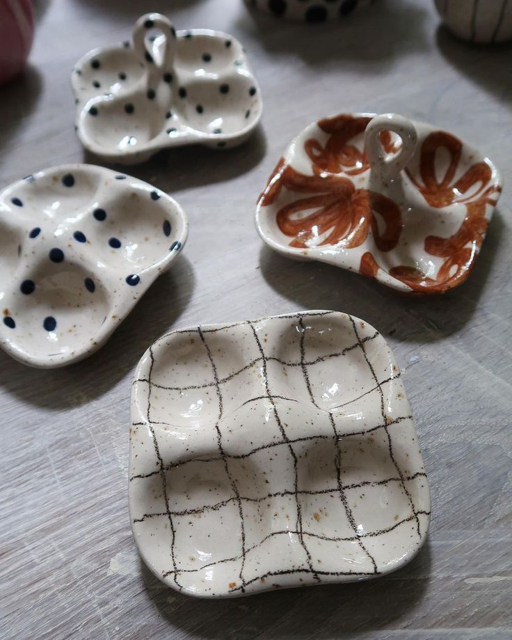 small ceramic dishes sitting on top of a wooden table