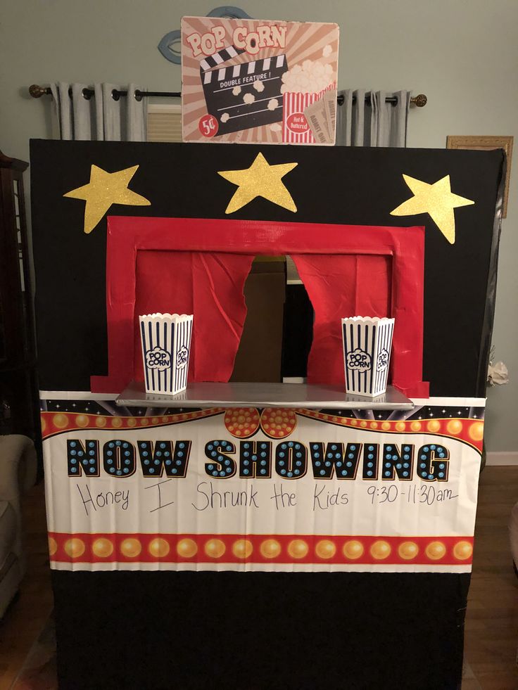 a small stage set up for a show with popcorn cups on the front and sides