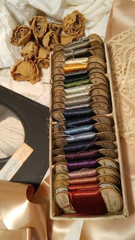 a box filled with lots of different colored thread