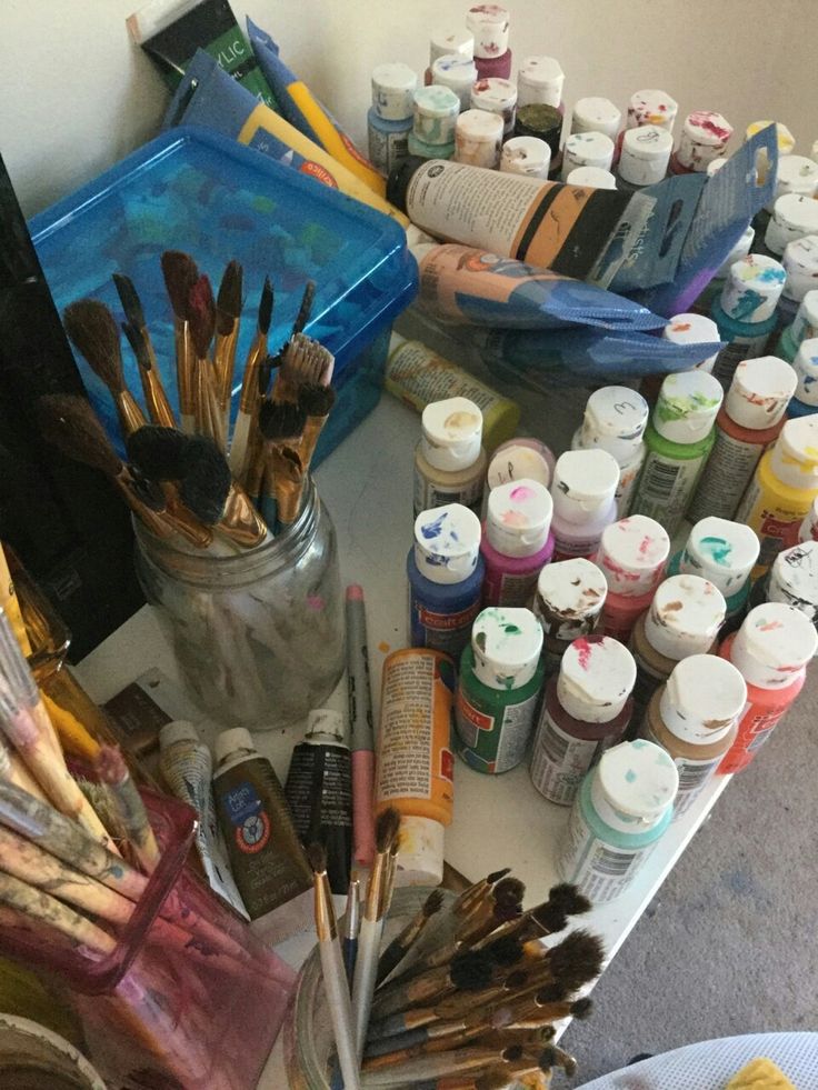 an assortment of paint brushes and other art supplies