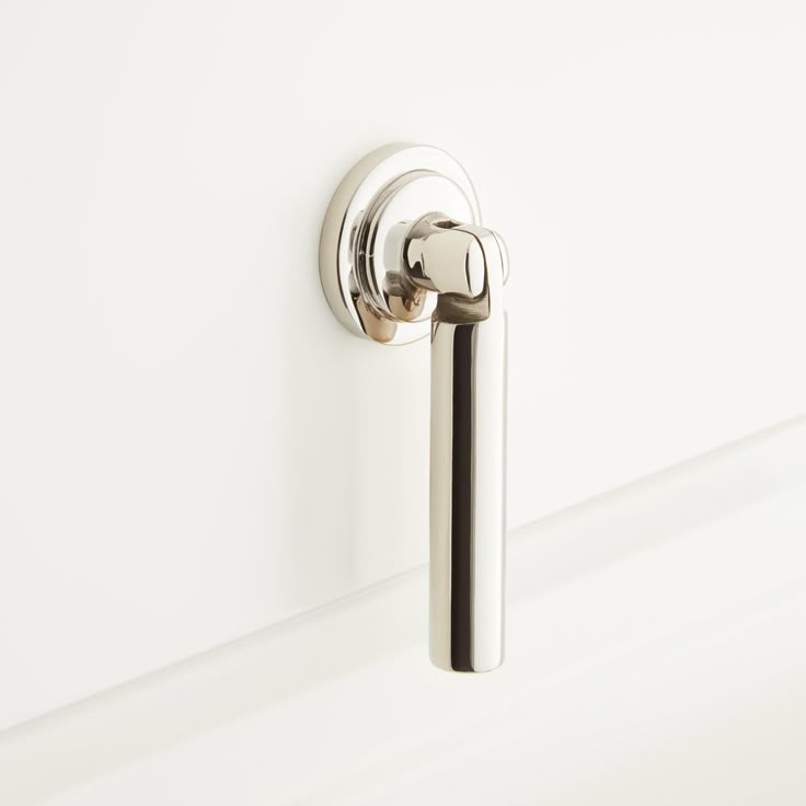 a door handle on the side of a white wall