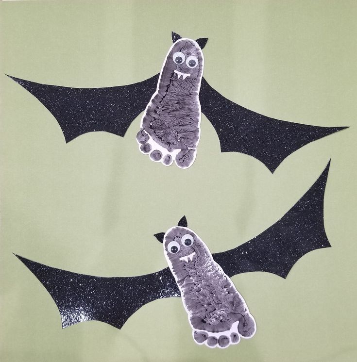 two bats that have been cut out to look like they are flying in the sky