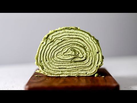 a piece of green cake sitting on top of a wooden stand