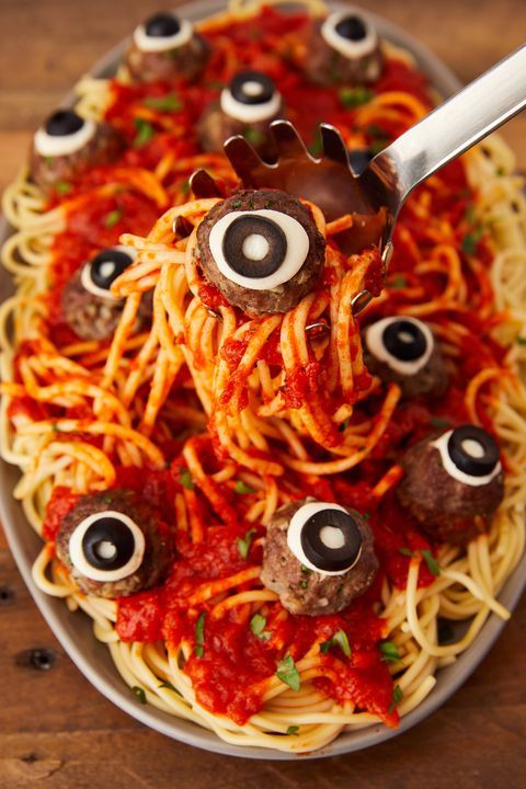 spaghetti with googly eyes and eyeballs on it is ready to be eaten by someone