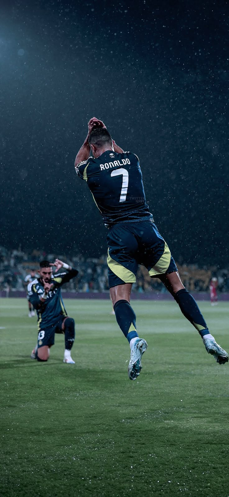 a soccer player jumping up in the air