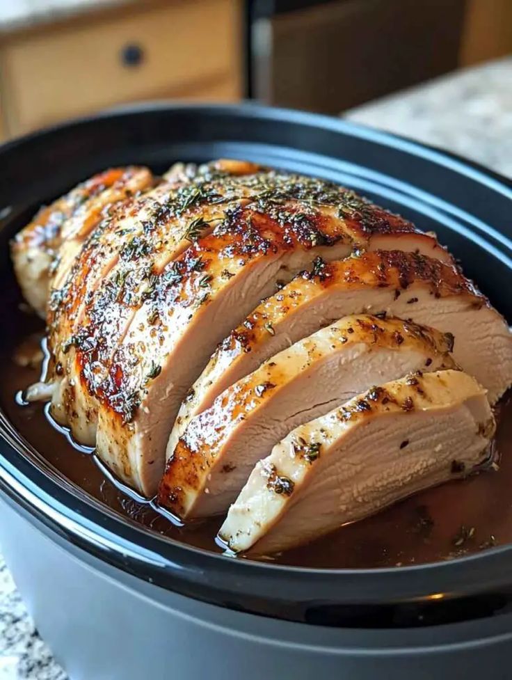 sliced pork in a slow cooker with seasoning on the side, ready to be cooked