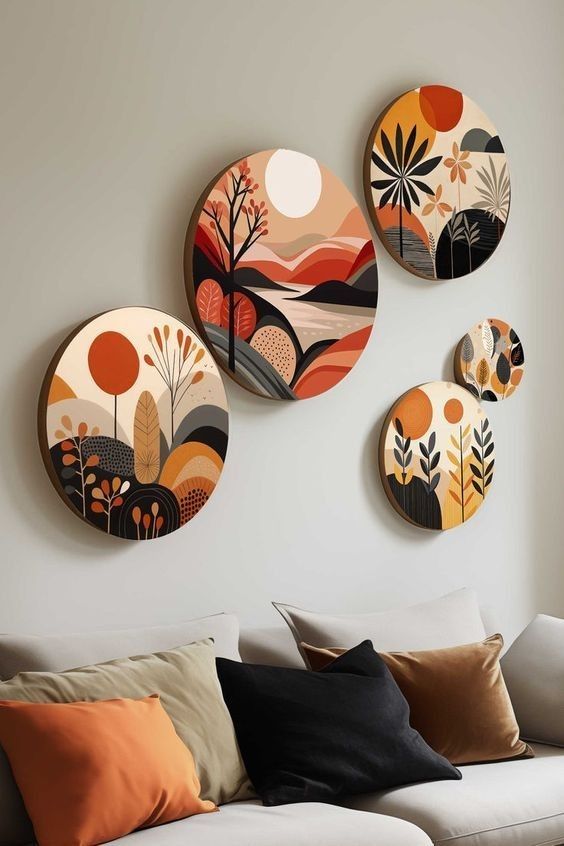 three decorative plates mounted on the wall above a couch in a room with white walls