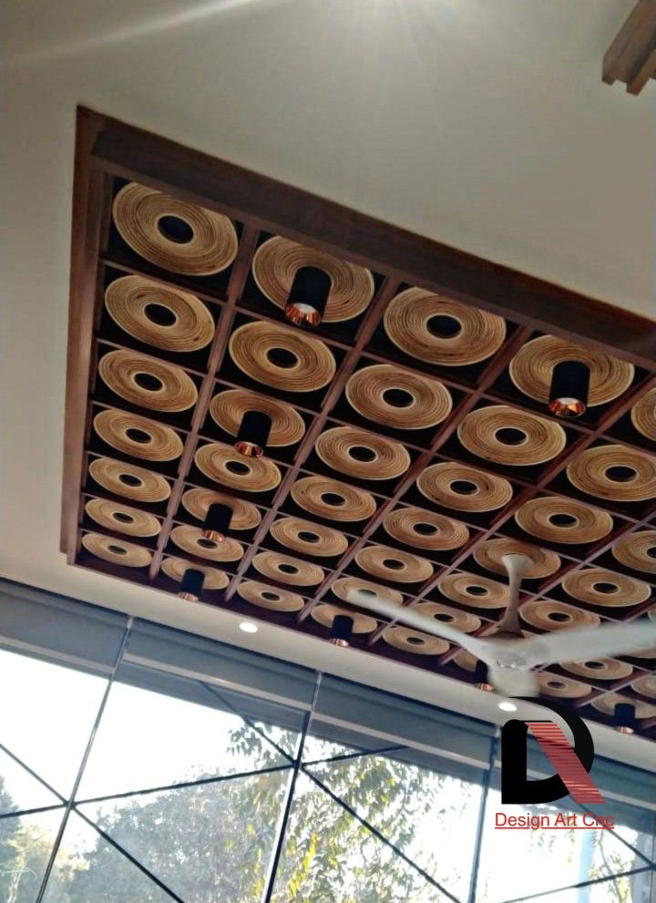 the ceiling is made out of wood and has round holes in it that look like circles