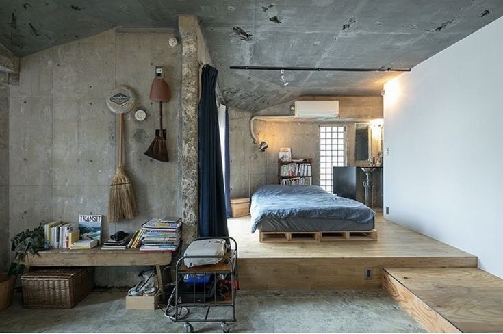 a bed sitting in the middle of a bedroom next to a wooden table and chair