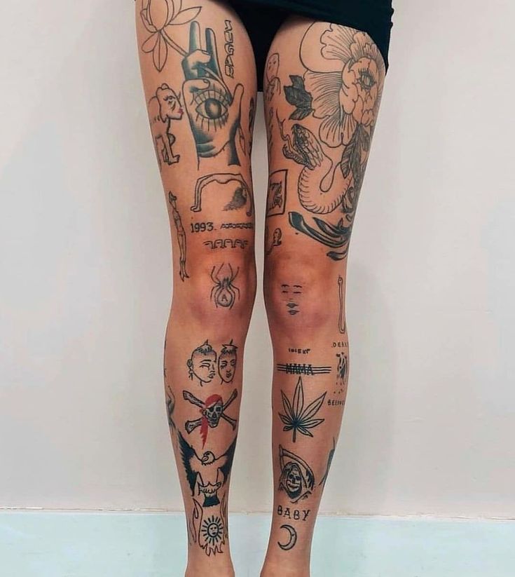 a woman's legs with tattoos on them